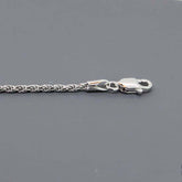 Close-up of a solid sterling silver rope chain necklace with a lobster clasp, showcasing diamond-cut details.